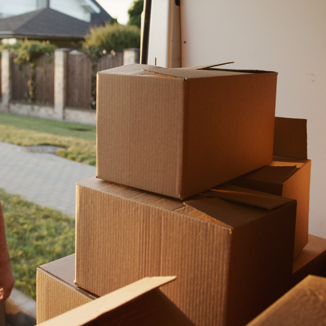 Packed boxes for a move while performing move-out cleaning services